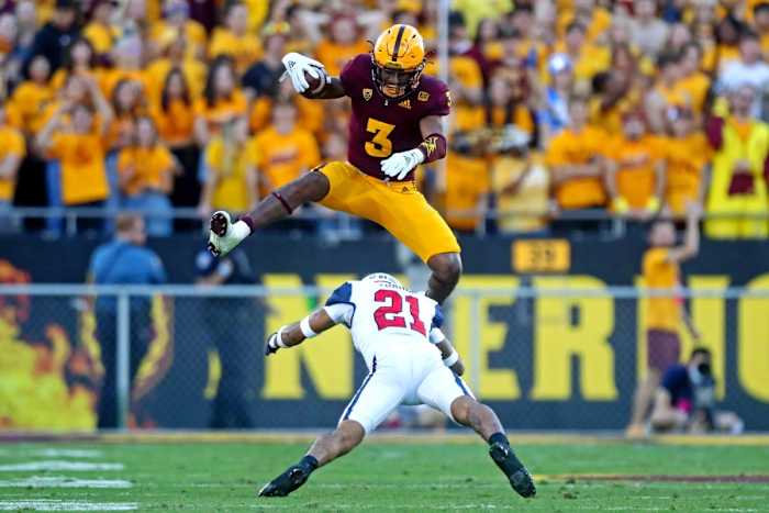 Nov 27, 2021; Tempe, Arizona, USA; Arizona State Sun Devils running back Rachaad White (3) jumps over Arizona Wildcats safety Jaxen Turner (21) during the second half at Sun Devil Stadium. Mandatory Credit: Mark J. Rebilas-USA TODAY Sports